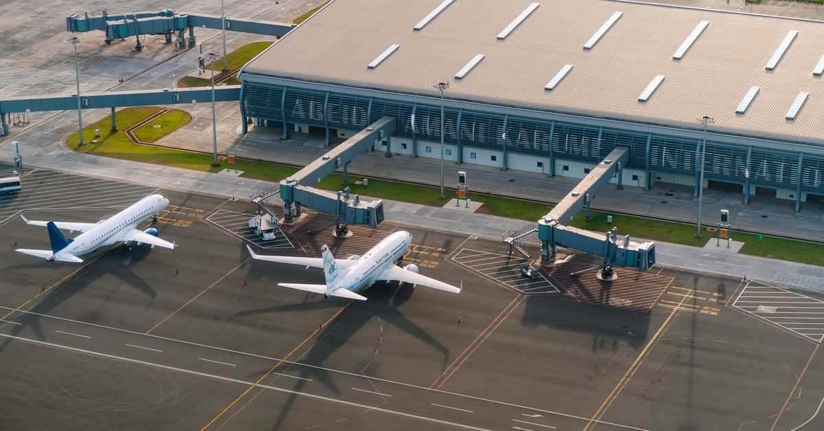 Aerial view of Abeid Amani Karume International Airport in Zanzibar, showing parked airplanes and terminal.