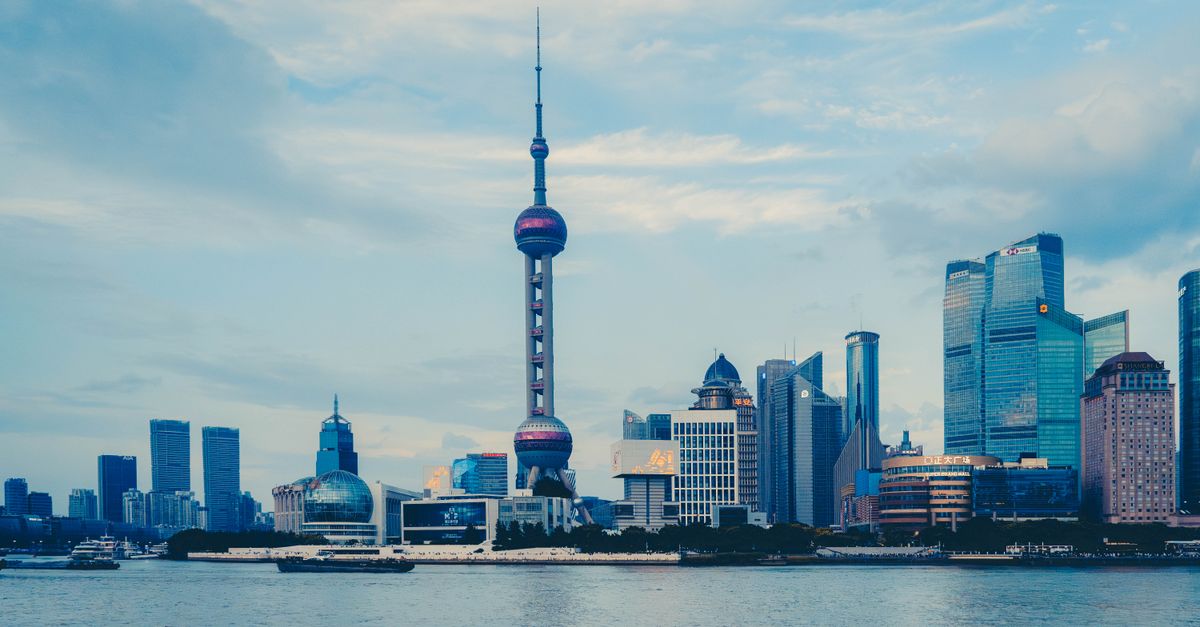 View of the Shanghai skyline with the iconic Oriental Pearl Tower on a clear day.
