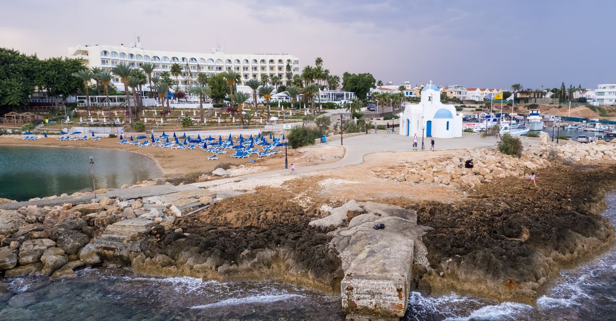 Aerial view of a church near the beach in Pernera, Cyprus, capturing the serene coastal landscape.