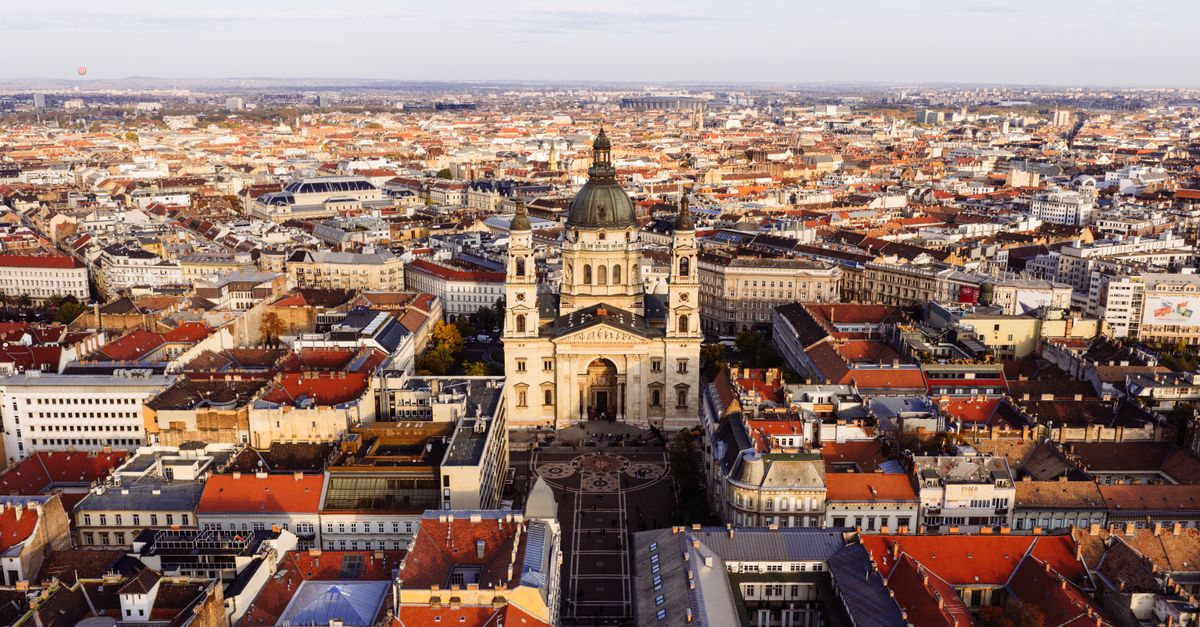 Explore a breathtaking aerial view of St. Stephen's Basilica in Budapest with its stunning architecture amid the city's landscape.