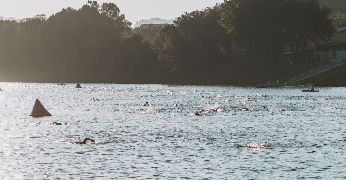 Swimmers participating in a river race event in Chattanooga, Tennessee, captured from an aerial view.