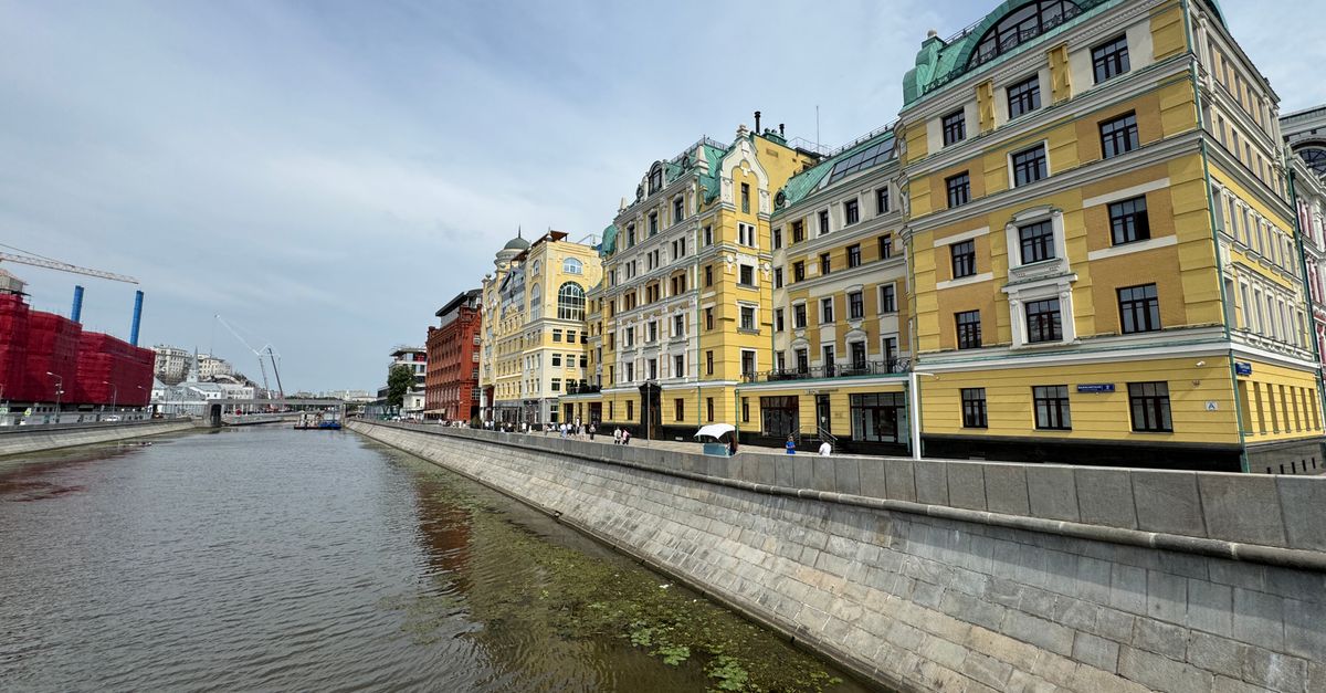 Historic buildings along the Yauza River in Moscow, showcasing vibrant architecture under a clear sky.