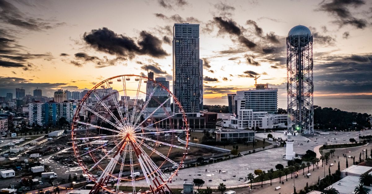 A panoramic view of Batumi's Ferris wheel and skyline at sunset, Georgia.