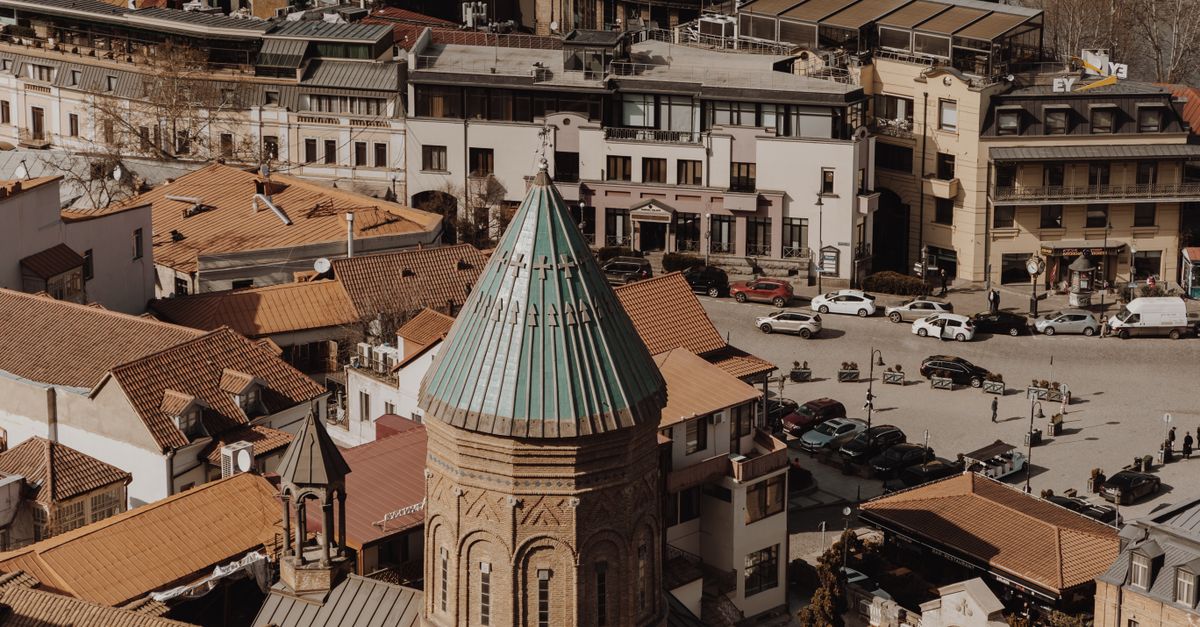 Aerial view of old town Tbilisi showcasing historic architecture and city life.