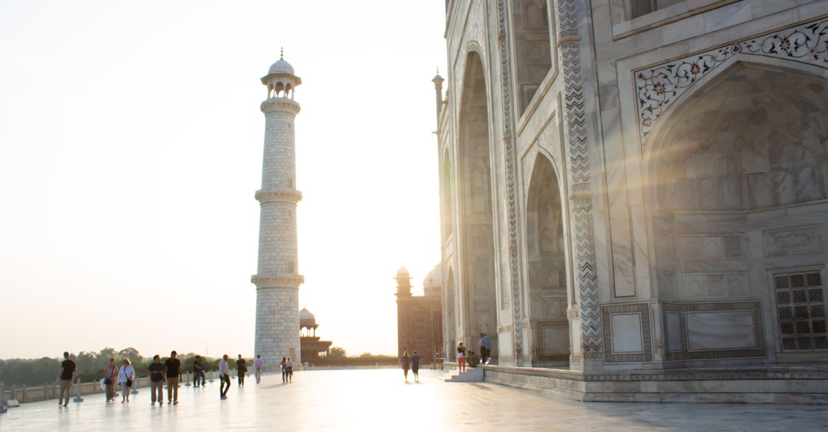 Beautiful sunrise at the iconic Taj Mahal with its majestic minaret in Agra, India.