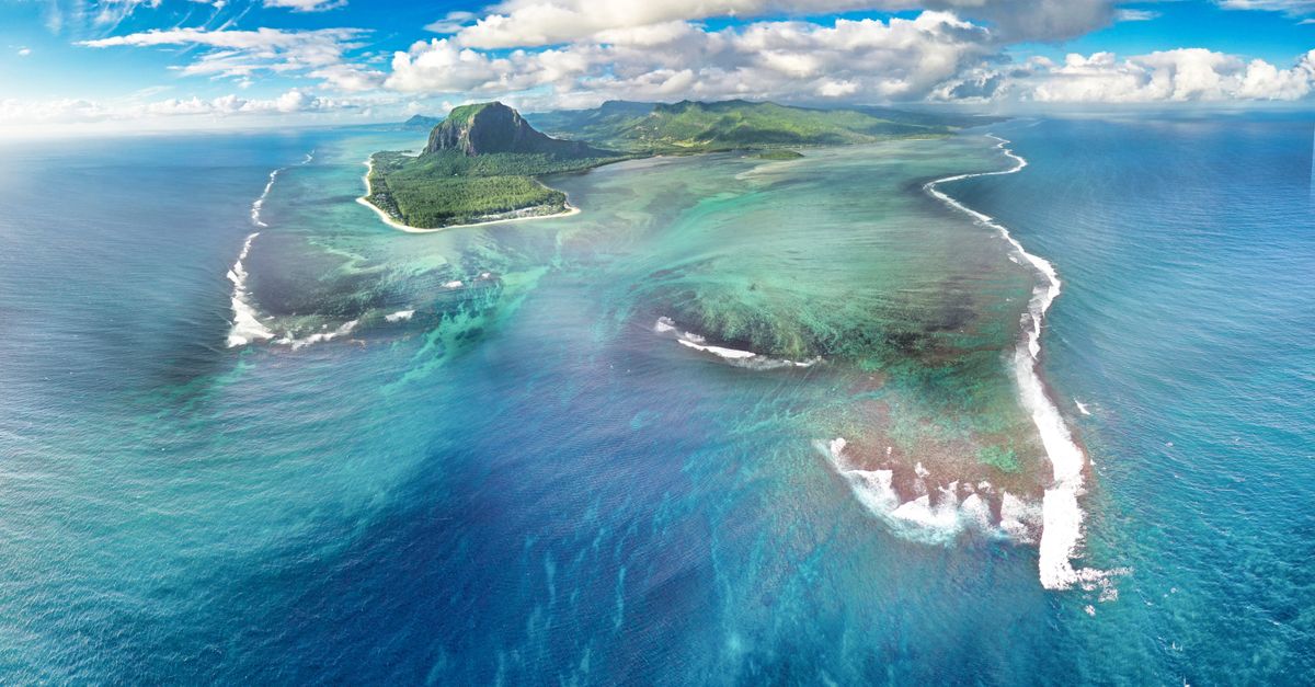 Explore the breathtaking Le Morne Peninsula, a UNESCO World Heritage site in Mauritius, from above.