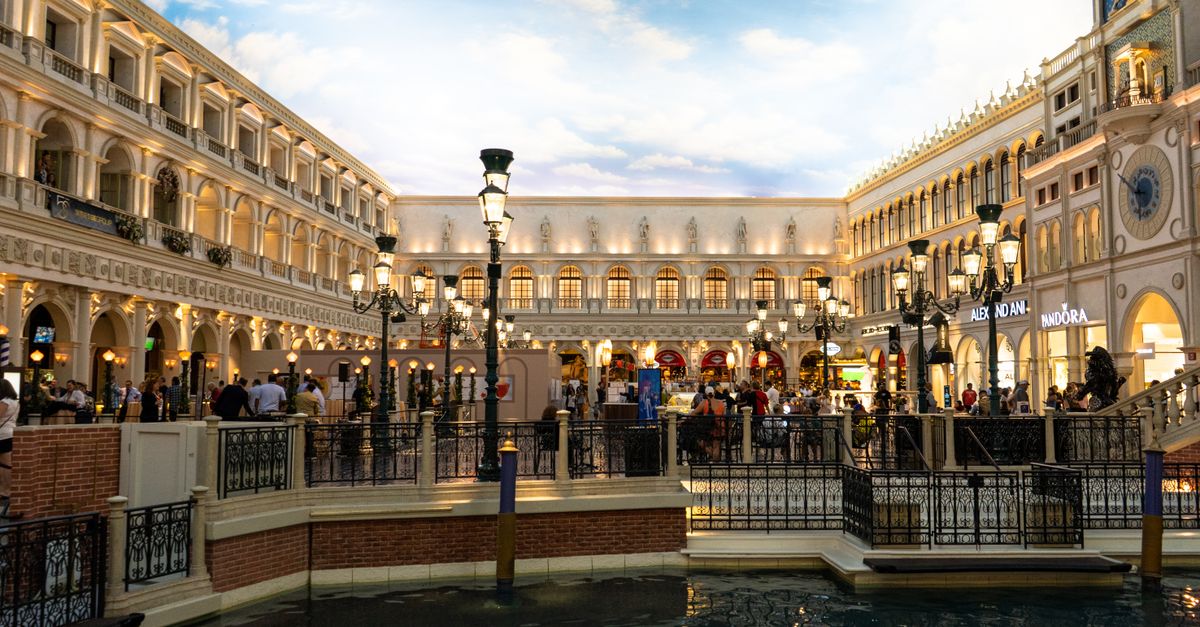 A bustling Venetian-themed shopping area with canals and classic architecture in Las Vegas.