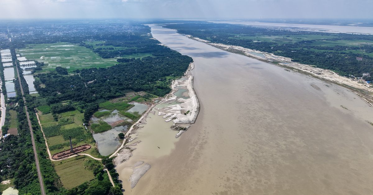 Sweeping aerial view of the Padma River flowing through Bangladesh's lush landscape.