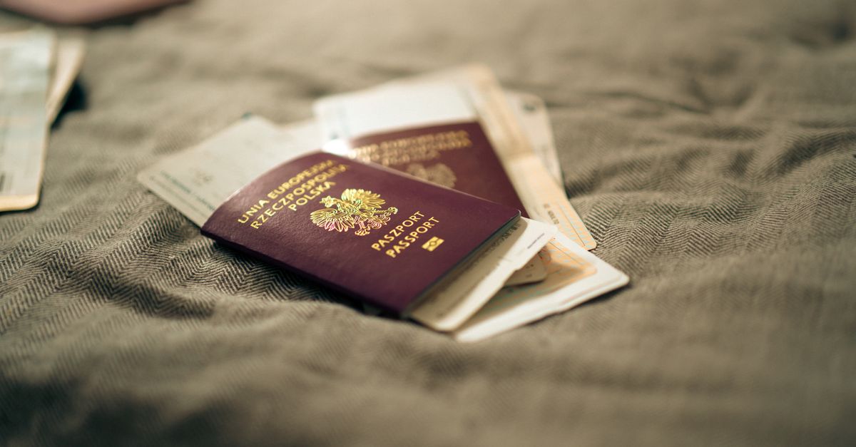 A close-up of a Polish passport and travel documents placed on a fabric surface, symbolizing travel and identity.