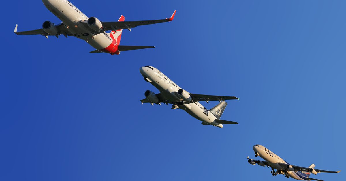 Three commercial airplanes soaring through a clear blue sky, highlighting aviation technology.