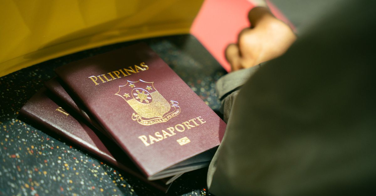 A close-up shot of Filipino passports at the airport, indicating travel and identity.