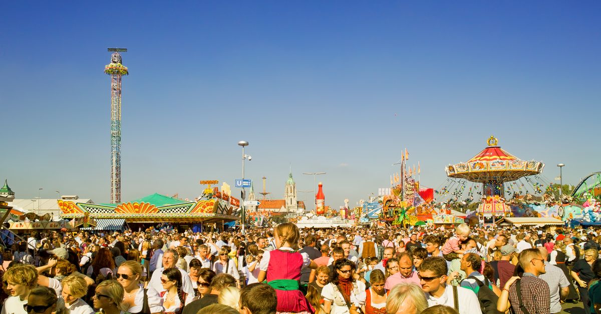 A lively scene at a crowded amusement park during the day.
