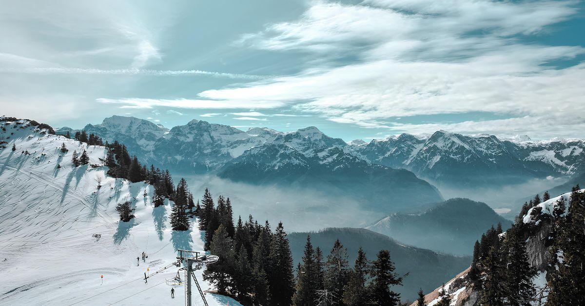 Breathtaking view of skiers on a snowy slope in Hinterstoder, Austria's Alpine region.