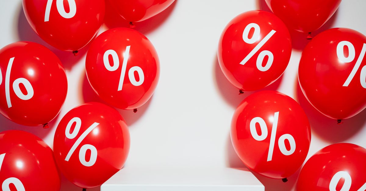 Red balloons with percentage signs, ideal for marketing promotions and sales events.