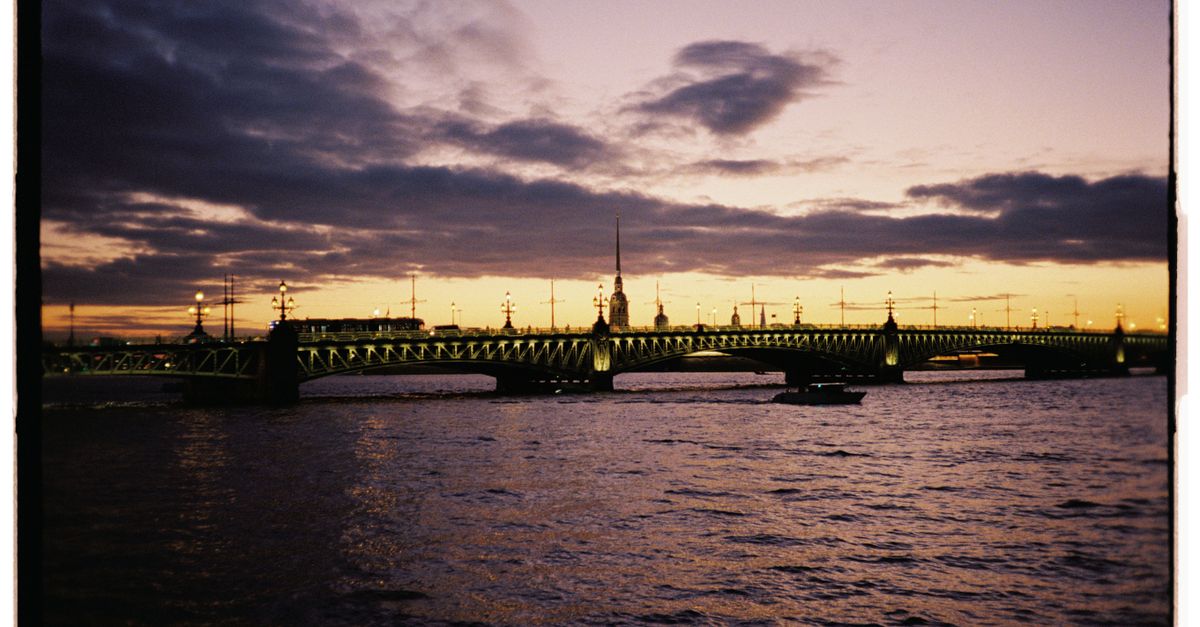Scenic view of Palace Bridge over the Neva River during sunset in Saint Petersburg.