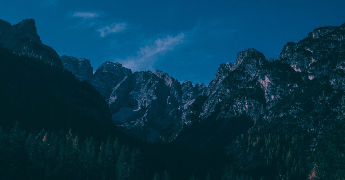 Stunning view of rugged mountains under a vibrant blue sky, perfect for nature exploration enthusiasts.