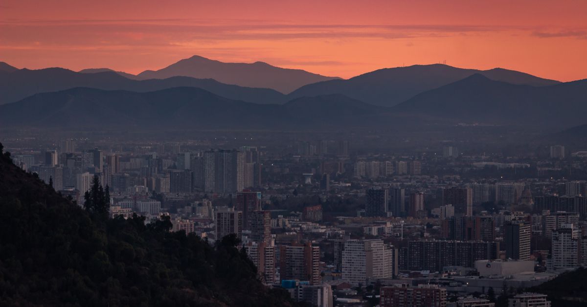Spectacular dusk over Santiago's skyline with Andes mountains backdrop.