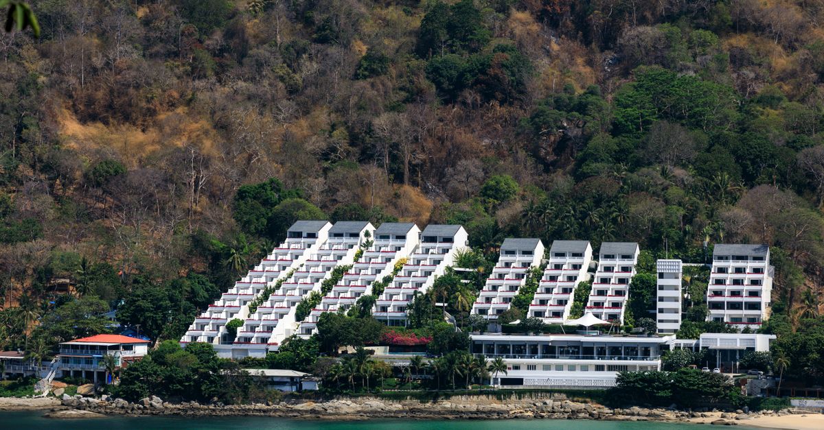 A scenic view of a modern resort nestled on the lush coastline of Phuket, Thailand.