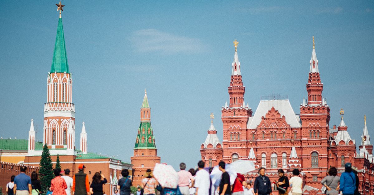 Tourists gathered at Red Square with views of the Kremlin and State Historical Museum in Moscow.