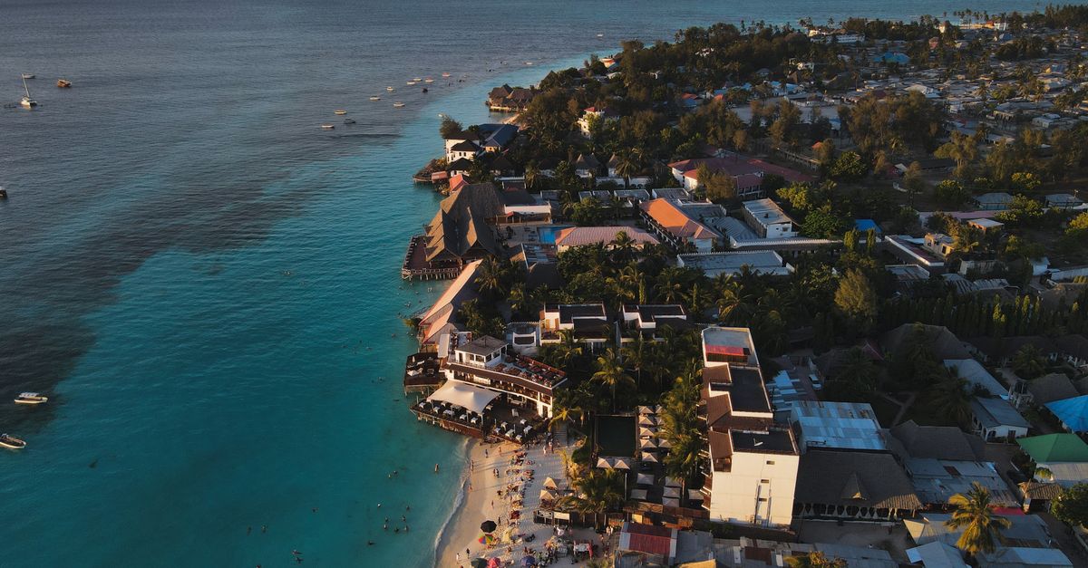 Stunning aerial photograph of Nungwi Beach, Zanzibar capturing the serene coastline at sunset.