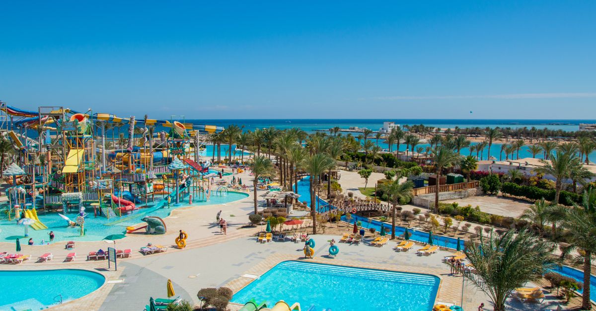 Aerial view of a lively tropical water park by the sea, perfect for family fun under the sun.