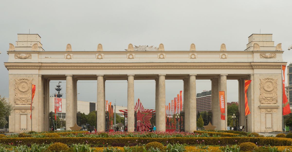 View of the Triumphal Gate and colorful flags in Gorky Park, Moscow, Russia.