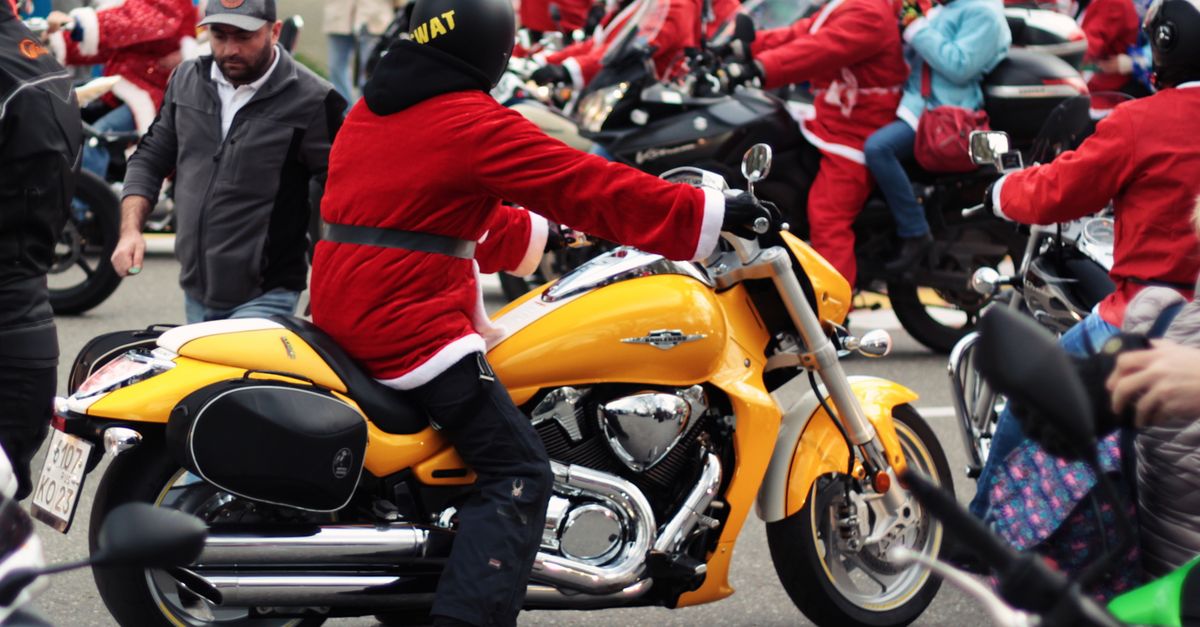A vibrant parade of motorcyclists in Santa costumes showcases holiday spirit on city streets.