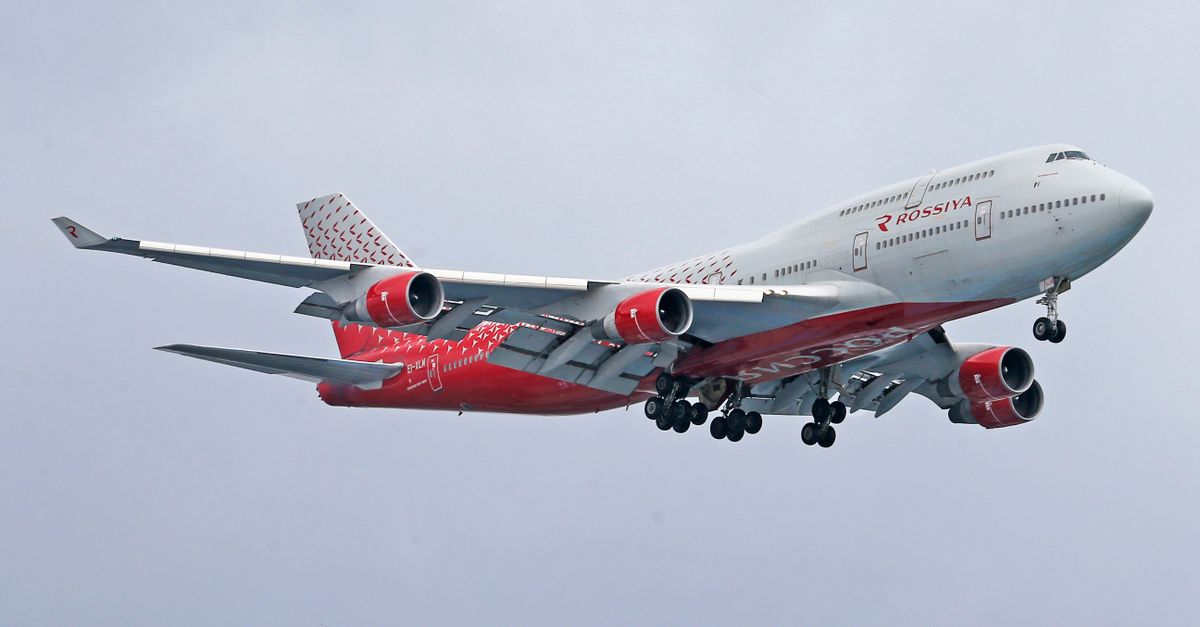 A Rossiya Airlines Boeing 747 flying through a cloudy sky.