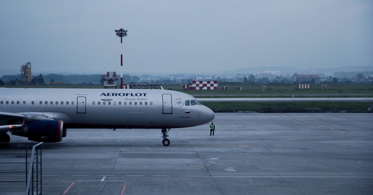 Aeroflot airplane stationed on an airport tarmac with overcast skies.