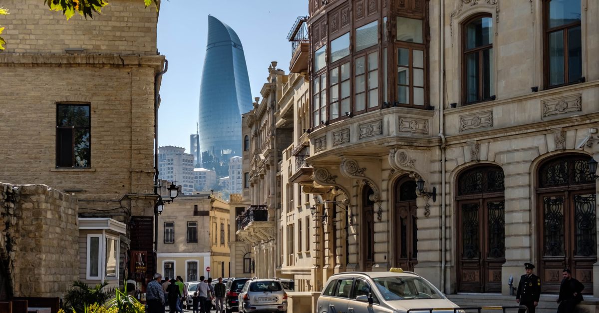 A charming street in Baku's Old City with a view of the iconic Flame Towers.