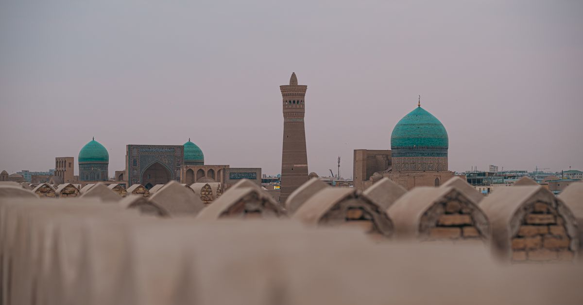 Beautiful view of Bukhara, Uzbekistan's ancient domes and minaret at sunset.