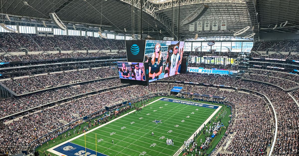 A packed AT&T Stadium in Arlington, Texas, showcasing a thrilling football game with enthusiastic fans.