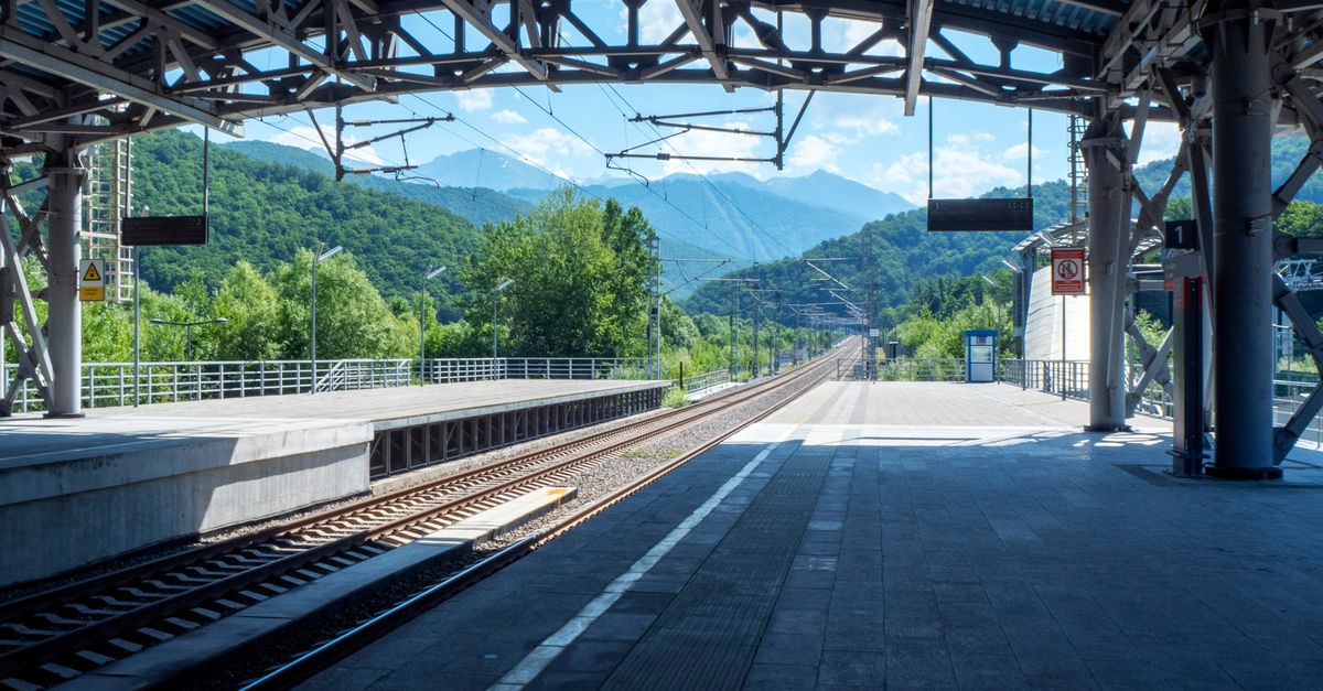 Scenic view of an empty railway station in Krasnaya Polyana, Russia with mountains in the background.