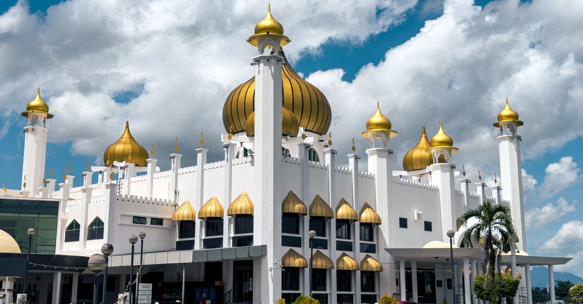 Majestic mosque with golden domes in Kuching, Sarawak, showcasing Islamic architecture.