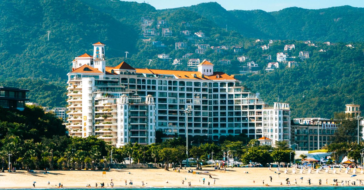 Beautiful beachfront resort with mountain backdrop, capturing coastal luxury and nature.