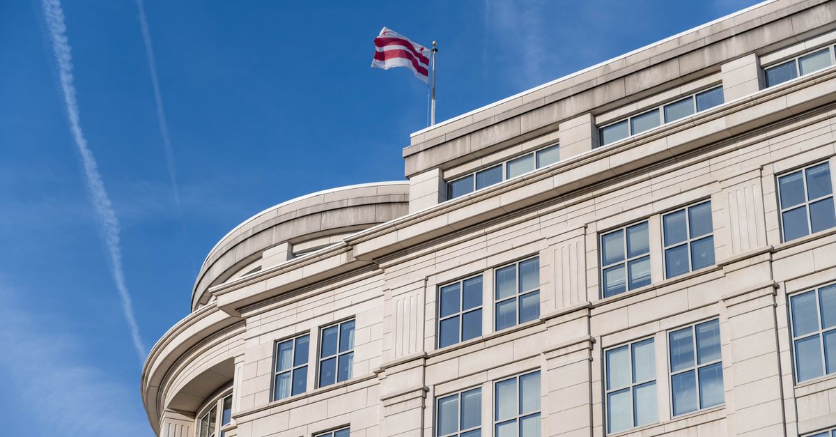 Exterior of a building in Washington DC with District of Columbia flag waving.
