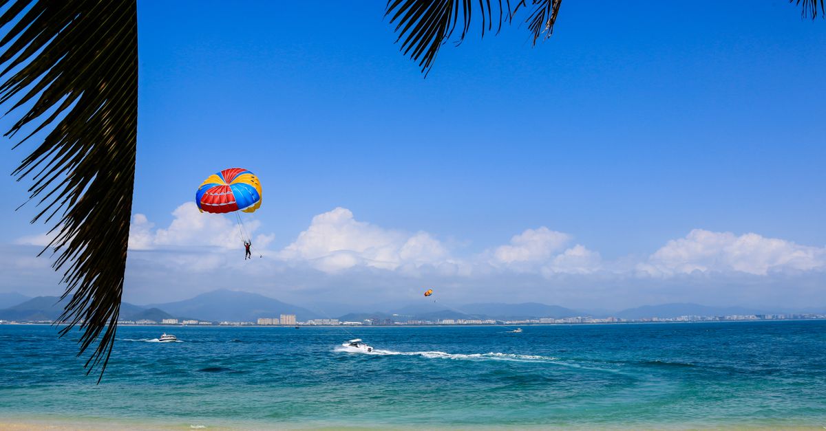 Enjoy thrilling parasailing on a sunny day in Sanya, China's tropical seaside paradise.
